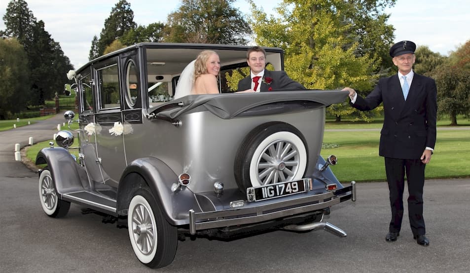 Imperial vintage limousine with Bride, Groom and chauffeur